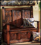 stunning medieval Monk's Bench reproduced for us complete with all its rich, handcarved details. Clergy members used it to store vestments before the advent of closets. Both stylish and functional, this heavyweight, high-back bench with carved panels, provides seating for two, and deep storage for items such as fine linens, books or treasures from a bygone era. 